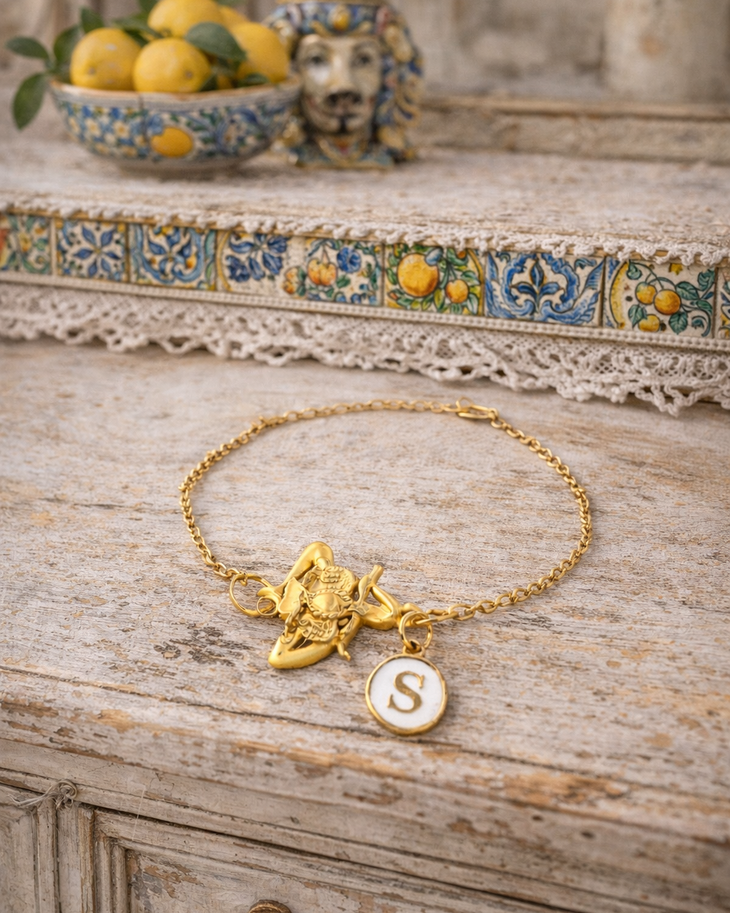 Gold tone bracelet with Trinacria and personalized initial charm